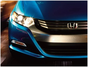 Front view of a blue Honda Insight showcasing its sleek design and distinctive headlights