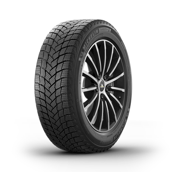 A close-up of a tire displayed against a solid black background, highlighting its tread and design features
