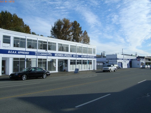 A parked car in front of a building displaying a sign that reads "Allstar Auto Repair.